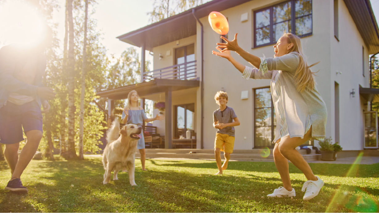 Family playing outside their home together | Pro Comfort Heating & Cooling