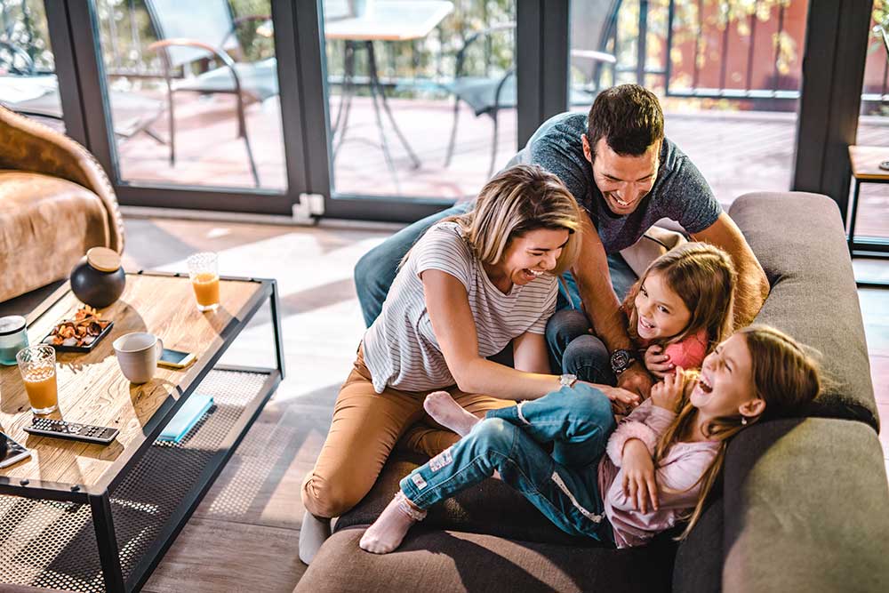 Happy Family in Living Room | Pro Comfort Heating & Cooling