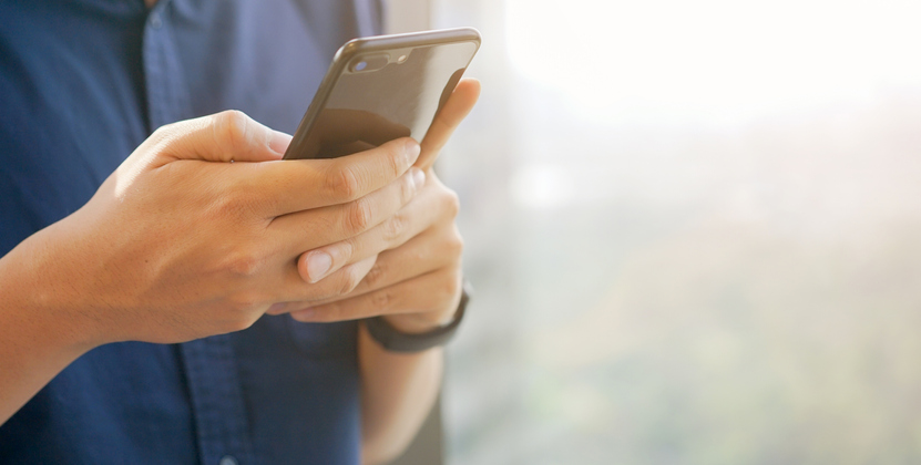 businessman holding smartphone | Pro Comfort Heating & Cooling