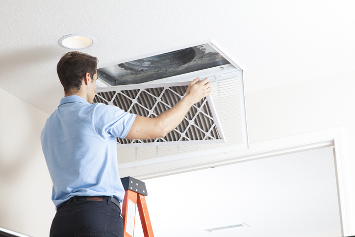 Technician cleaning duct | Pro Comfort Heating & Cooling